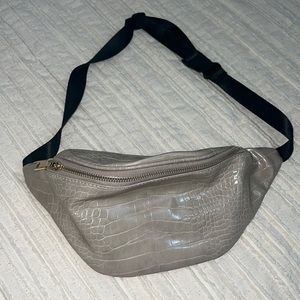 Tan crossbody strap bag with black strap